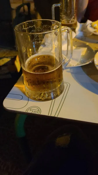 Vertical Shot Half Empty Glass Beer Table — kuvapankkivalokuva