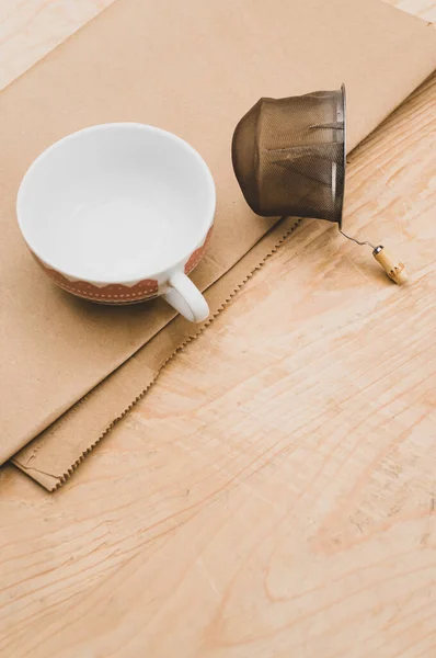 Metal Tea Strainer Decorated Tea Cup Kraft Paper Wooden Background — 스톡 사진