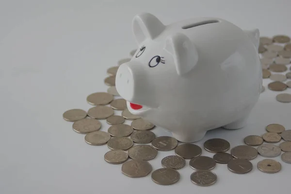 Closeup White Piggy Bank Coins White Surface — Stock Fotó
