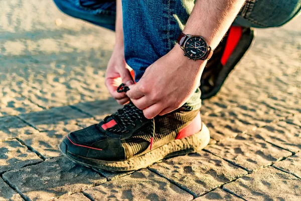 Closeup Shot Male Tying Shoelaces Outdoors — стоковое фото