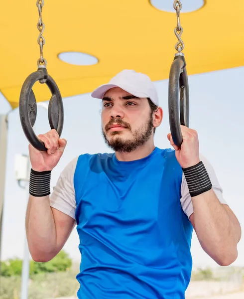 Strong Man His Hand Squeezes Sports Gymnastic Ring — Photo