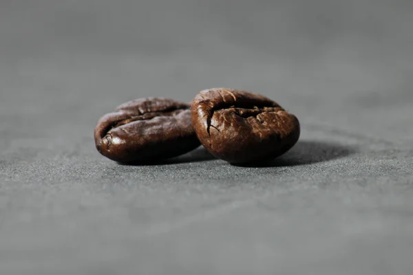 Closeup Two Roasted Coffee Beans Gray Surface Blurry Background — Stock Photo, Image