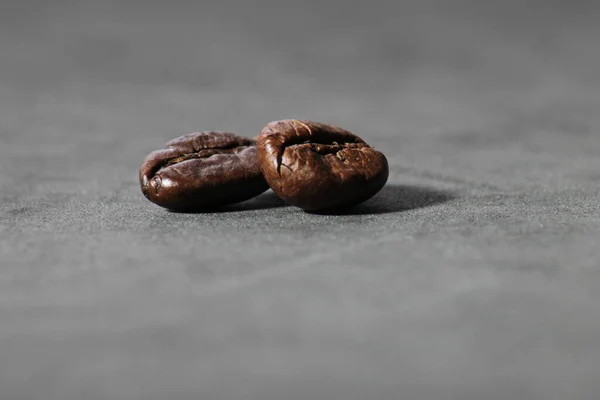 Closeup Two Roasted Coffee Beans Gray Surface Blurry Background — Stock Photo, Image