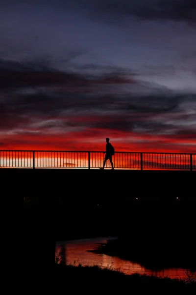 Silhouette Man Walking Bridge Orange Sunset Sky Background — Stock Photo, Image
