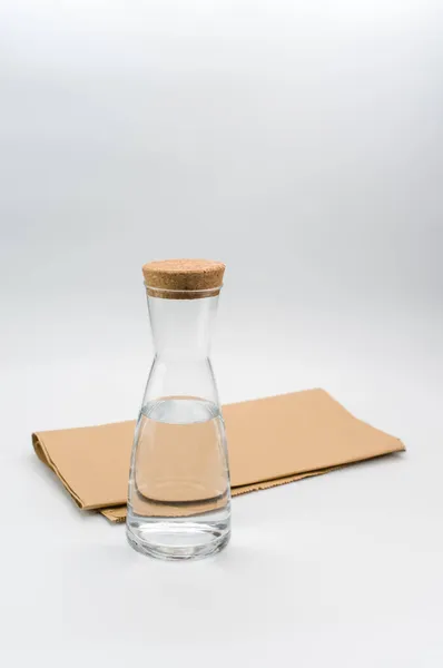 Glass Flask Filled Pure Clean Water White Food Paper Background — Stock Photo, Image
