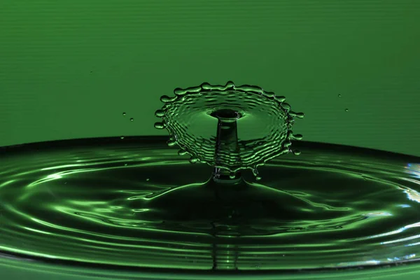 Een Plons Een Groen Oppervlak Dat Resulteert Watersculpturen — Stockfoto