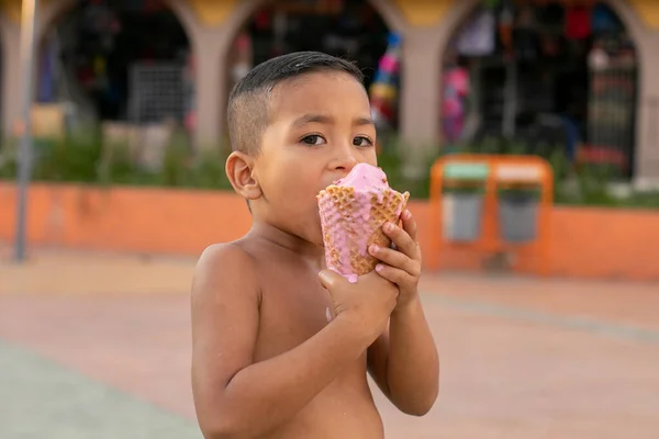 Cheerful Hispanic Boy Walking Park Shirt Eating Ice Cream — стоковое фото
