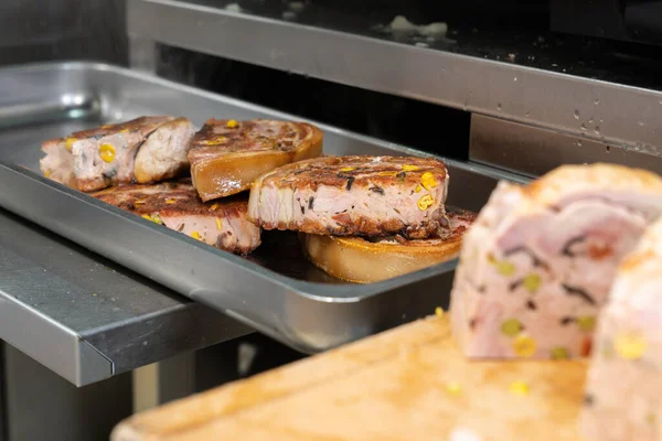 A closeup of preparing food in a store of a French traditional pork butcher