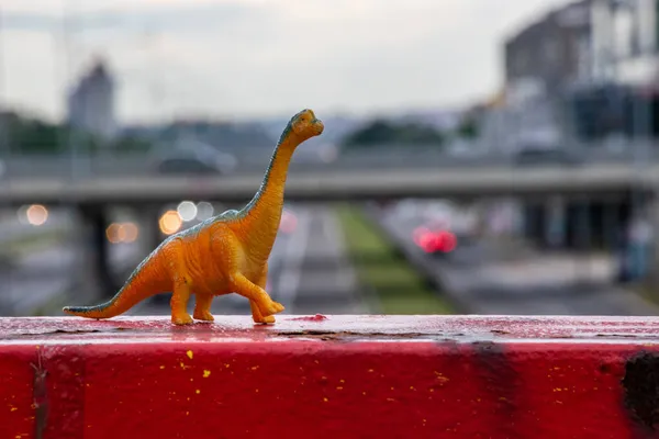 A closeup shot of a little dinosaur toy outdoor