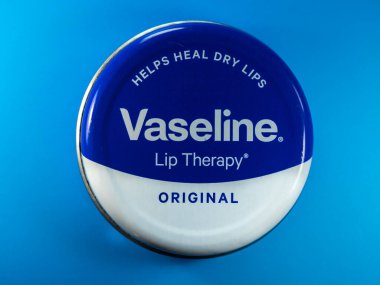 MANCHESTER, UNITED KINGDOM - Nov 21, 2021: Tin of vaseline lip therapy on a blue background clipart