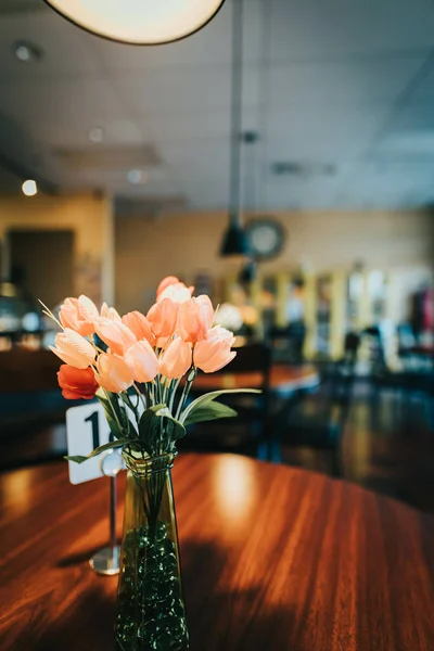Vertical Shot Tulips Glass Vase Wooden Table Restaurant —  Fotos de Stock