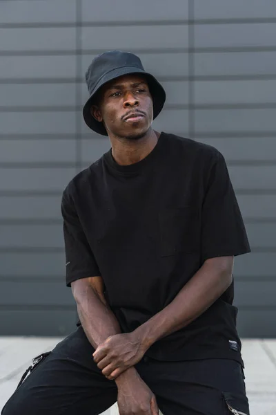 Vertical Shot Young Black Man Street Style Clothes Posing Sitting — ストック写真