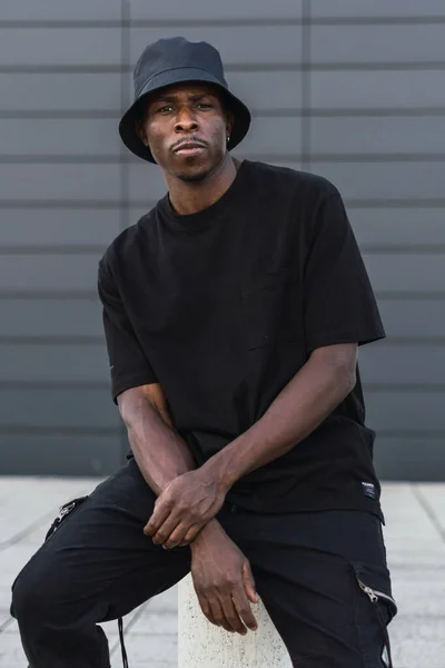 Vertical Shot Young Black Man Street Style Clothes Sitting Pillar — ストック写真