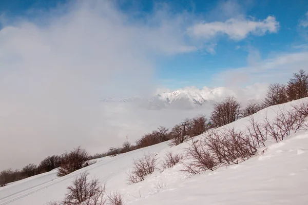 Hermoso Tiro Montañas Cubiertas Nieve Detrás Las Nubes Invierno — Foto de Stock