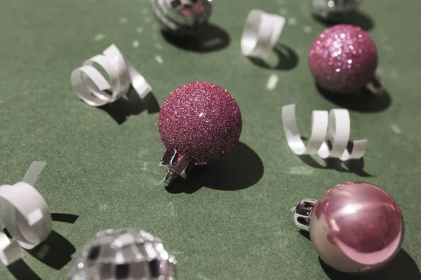 Feestelijke Compositie Met Roze Kerstballen Witte Linten Het Groene Oppervlak — Stockfoto