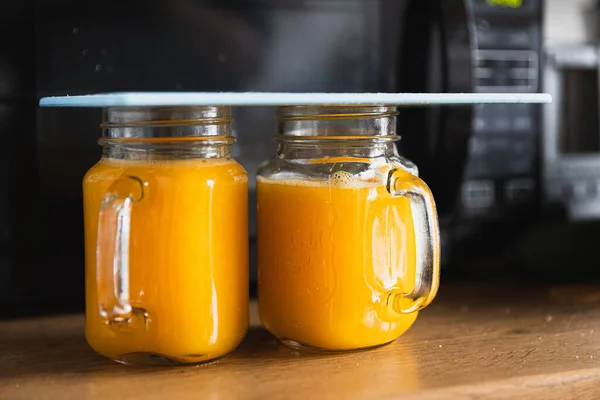 Closeup Two Glasses Freshly Squeezed Orange Juice Wooden Table — Φωτογραφία Αρχείου