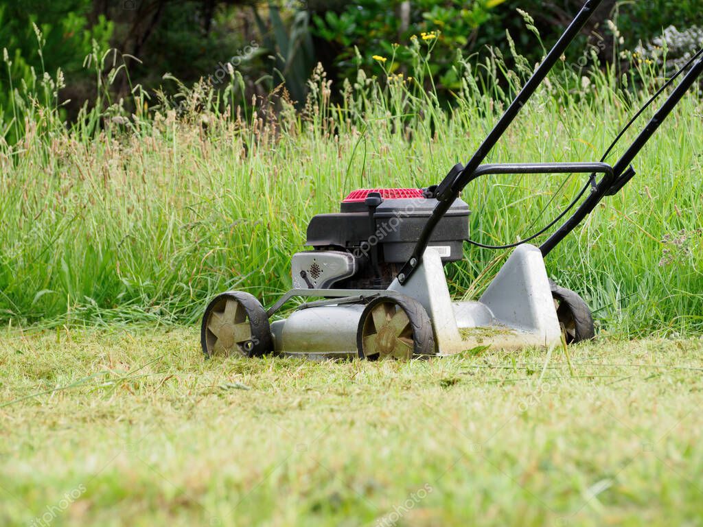AUCKLAND, NEW ZEALAND - Nov 30, 2021: Old Masport lawn mower mulcher with Briggs and Stratton 650 series 190cc engine. Auckland, New Zealand - November 30 2021