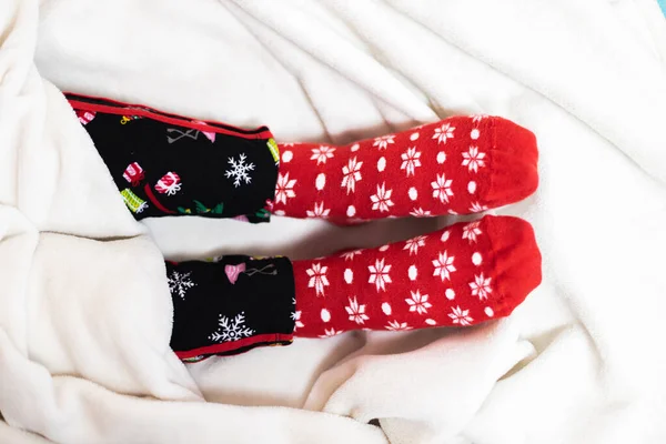 Closeup Shot Person Cozy Christmas Pajamas Socks Bed — 图库照片