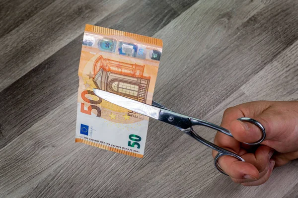 Human Hands Holding Scissors Cut Euro Banknotes Wooden Background — Zdjęcie stockowe