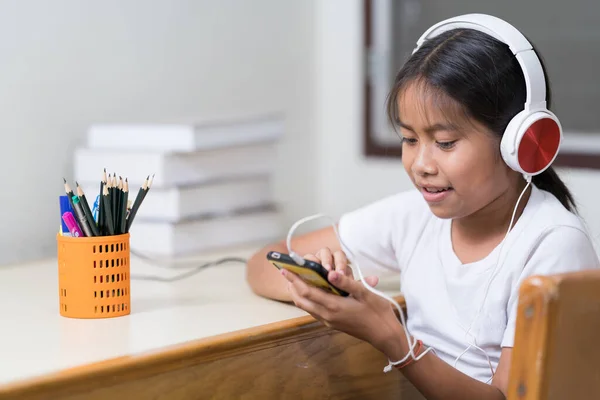 Closeup Little Girl Headphones Looking Smartphone — Foto Stock