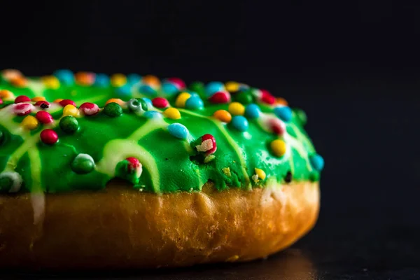 Shallow Focus Shot Green Glazed Donut Sprinkles Isolated Black Background — Stock Fotó