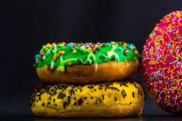 Yummy Glazed Donuts Colorful Sprinkles Isolated Black Background — Stockfoto