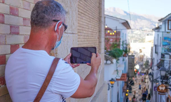 Man Enjoying His Time Small Tablet Earphones Taking Pictures — стоковое фото