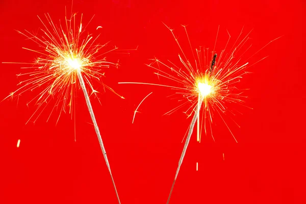 Closeup Two Bright Sparklers Christmas Isolated Red Background — Foto Stock