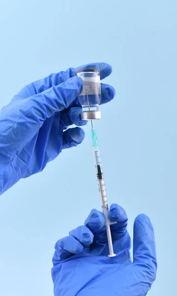 Doctor Hands Blue Gloves Inserting Vaccine Syringe — стоковое фото