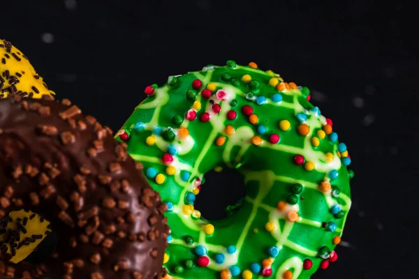 Fresh Tasty Colored Donuts Sprinkles Black Background — Stockfoto