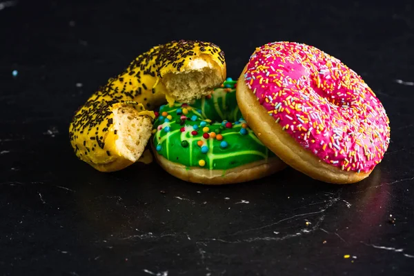 Bitten Yellow Glazed Donut Sprinkles Isolated Closeup Colorful Donuts — Stockfoto