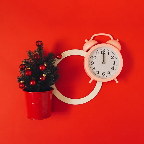 Closeup Small Potted Christmas Tree Ornaments Alarm Clock Red Surface — стоковое фото
