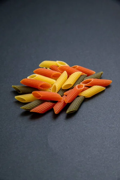 Colored Raw Penne Pasta Dark Background — стоковое фото