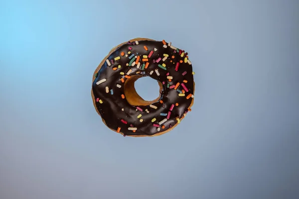 Donut Chocolate Frosting Rainbow Sprinkles Bluebackground — Stock Fotó