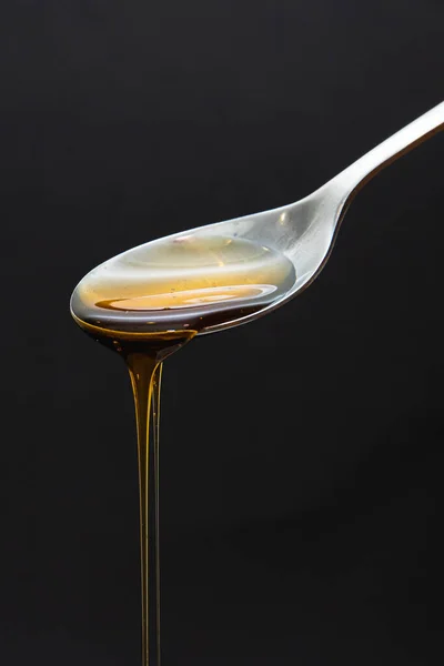 Honey Dripping Spoon Dark Background — Stock fotografie