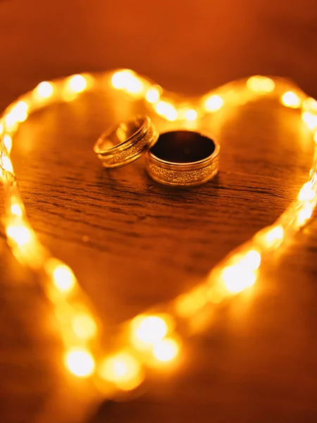 Close Shot Two Golden Engagement Rings Middle Glowing Heart Shaped — стоковое фото