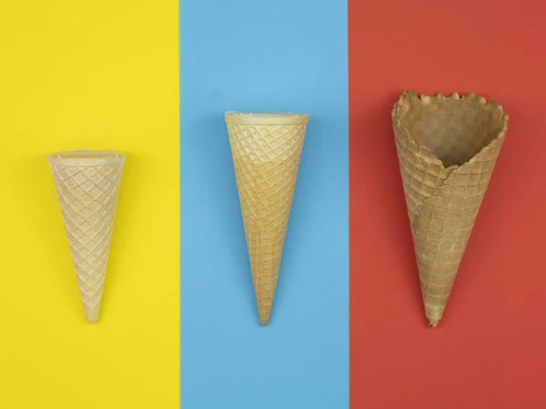Three Sizes Ice Cream Cones Yellow Blue Red Background — Stockfoto