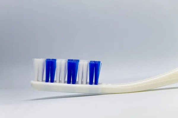 White Toothbrush Blue White Bristles Gray Background — Stock Photo, Image