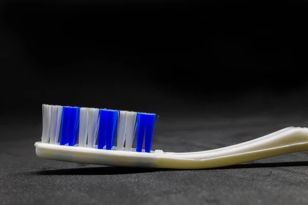 White Toothbrush Blue White Bristles Dark Background — Stock Photo, Image