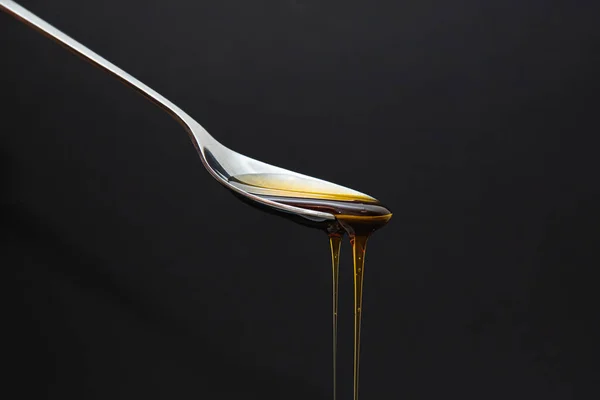 Honey Dripping Spoon Dark Background — Stock fotografie