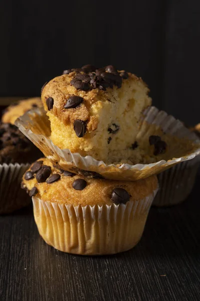 Vertical Closeup Shot Delicious Vanilla Muffins Chocolate Chips Black Background — стоковое фото