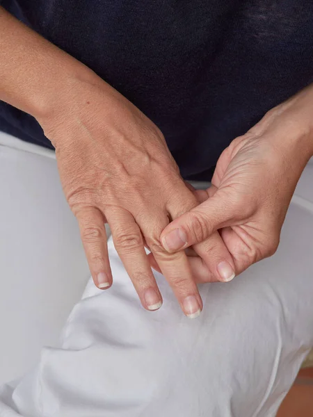 Woman Sitting Home Massaging Her Hand Due Pain Caused Osteoarthritis — Stockfoto