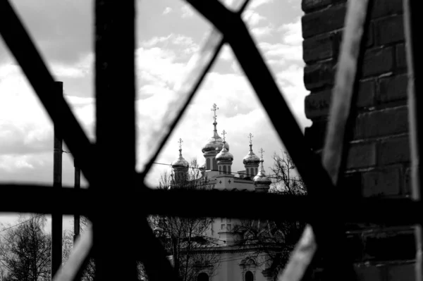 金属製の窓から曇り空のロシア正教会のグレースケールビュー — ストック写真