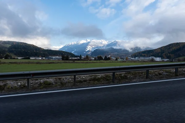 Strzał Okna Kierowcy Elektrycznego Samochodu Pokrytymi Śniegiem Górami Alp Zimny — Zdjęcie stockowe