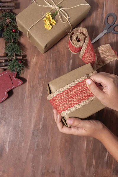 Top View Person Wrapping Christmas Present Jute Fabric Ribbon Red — 图库照片