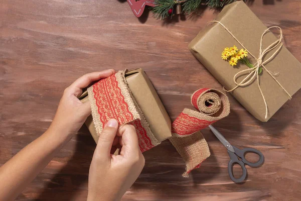 Top View Person Wrapping Christmas Present Jute Fabric Ribbon Red — 图库照片