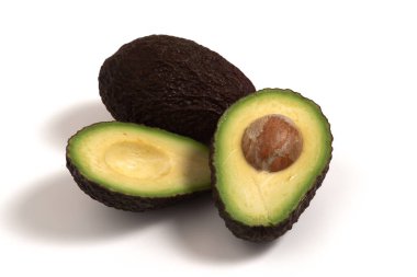 A closeup of sliced fresh avocados on the white surface clipart