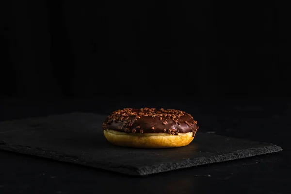 Ένα Κοντινό Πλάνο Ενός Ντόνατ Γλασαρισμένα Τρούφα Μαύρο Φόντο — Φωτογραφία Αρχείου