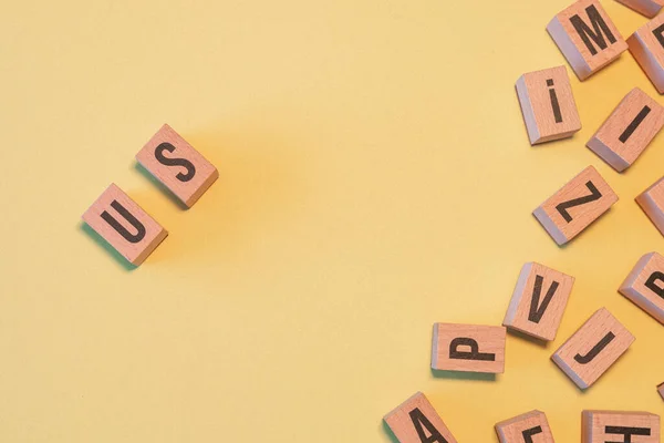 Word Taken Pile Wooden Letter Blocks Yellow Background Copy Space — Stock Fotó