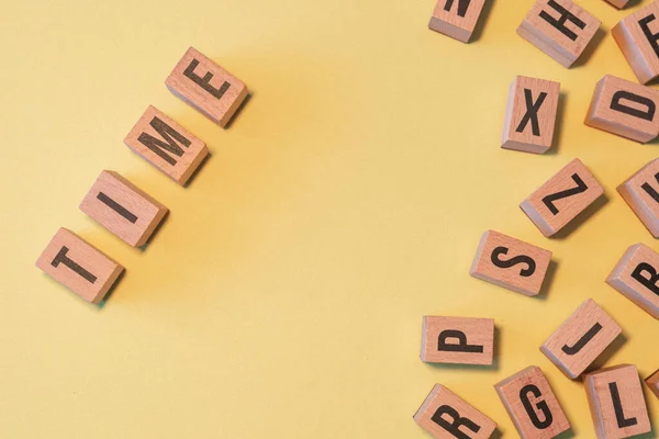 Word Time Taken Pile Wooden Letter Blocks Yellow Background Copy — Stockfoto